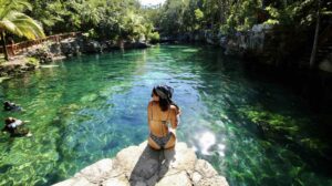 jorge-fernandez-salas-Mexican Caribbesan Travel woman sitting on rockunsplash